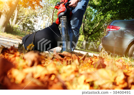 Man working with leaf blower Man working with leaf blower 38400491