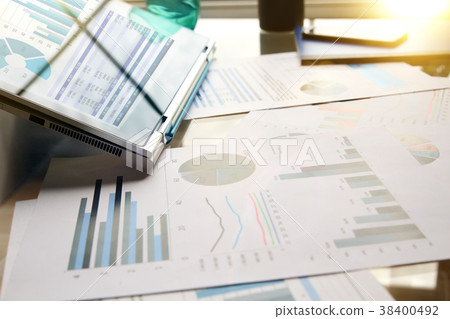 working place with laptop, graphs at the office working place with laptop, graphs at the office 38400492