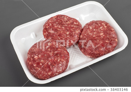 Tray with raw beef burgers isolated on gray Tray with raw beef burgers isolated on gray 38403146