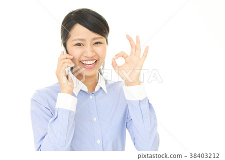 A woman talking on a smartphone 38403212