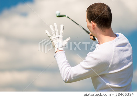 A golfer holds the ball on a golf club, the view A golfer holds the ball on a golf club, the view 38406354