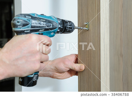 A man is installing a hook. 38406788