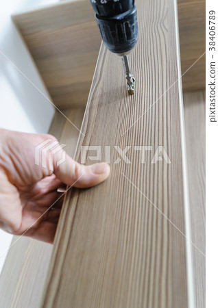 A man is installing a hook. 38406789