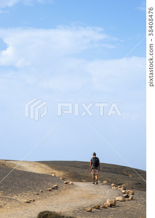 young man walking outdoors in Fuerteventura, Spain 38408476