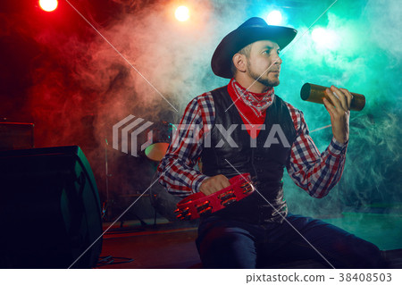 The actor plays percussion. 38408503