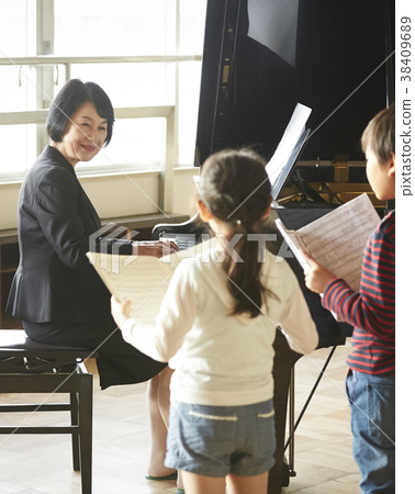 Teachers and students in the music room 38409689