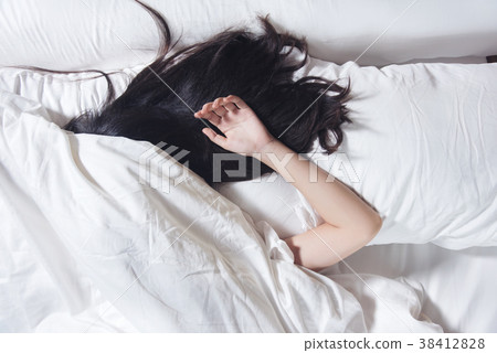 woman black hair sleeping on pillow and the bed 38412828