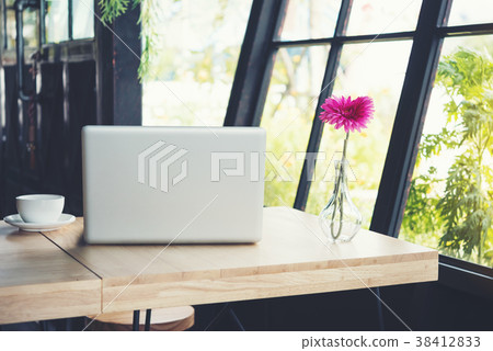 cup of coffee on the desk with laptop and flower cup of coffee on the desk with laptop and flower 38412833
