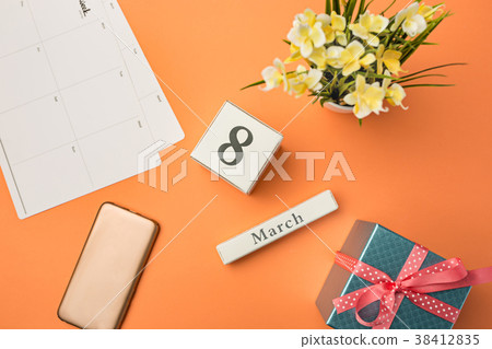 The top view of orange desk with phone, gift The top view of orange desk with phone, gift 38412835