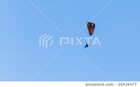 Paraglider flies in blue sky, ultralight aircraft 38416477