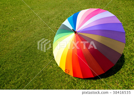 rainbow umbrella in grass field rainbow umbrella in grass field 38416535