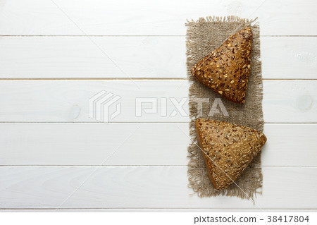 Several small multi grain triangular shaped bread 38417804