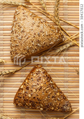 Rustic bread and wheat on an old vintage planked 38417812