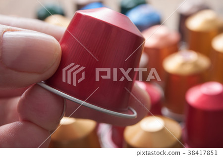 closeup of colorful espresso coffee doses in hand 38417851