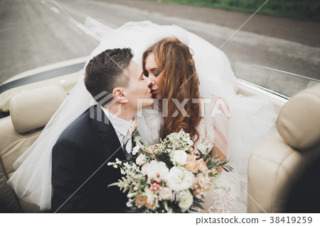 Stylish wedding couple, bride, groom kissing and Stylish wedding couple, bride, groom kissing and 38419259