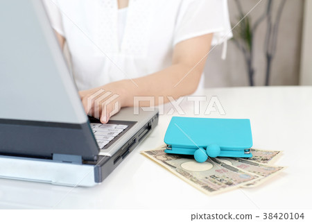 A woman enjoying a laptop computer 38420104