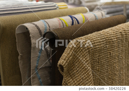 New carpets hang in the mall. Selection of carpets 38420226