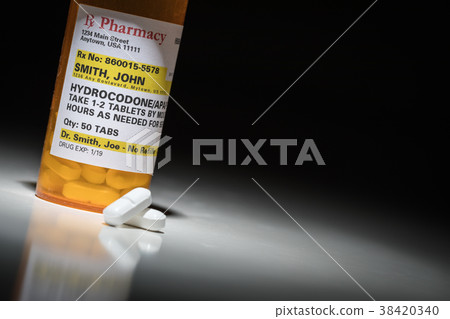 Hydrocodone Pills and Prescription Bottle  38420340