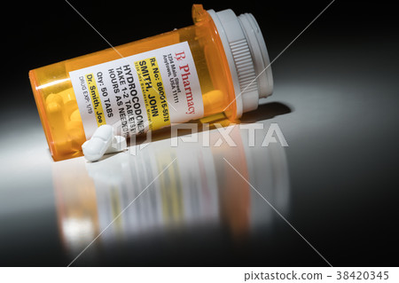 Hydrocodone Pills and Prescription Bottle  38420345