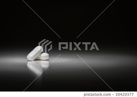 Hydrocodone Prescription Pills Under Spot Light. 38420377