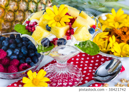 Breakfast: muesli, yogurt, fruit, edible flowers 38421742