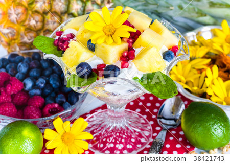 Breakfast: muesli, yogurt, fruit, edible flowers 38421743