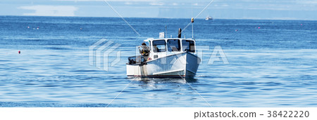 Fisherman pulling up lobster trap in the ocean 38422220