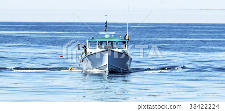 Lobster boat with fisherman with lobster trap 38422224