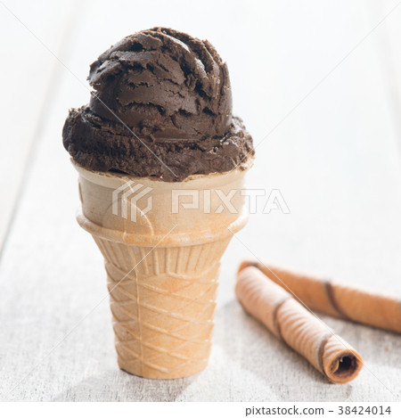 Chocolate ice cream in waffle cone Chocolate ice cream in waffle cone 38424014