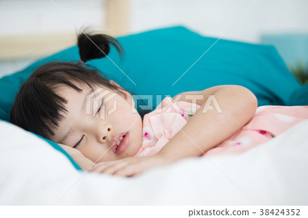 The lovely girl sleeping on the bed 38424352