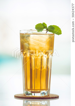 Iced tea mint on wooden coaster background . 38424377