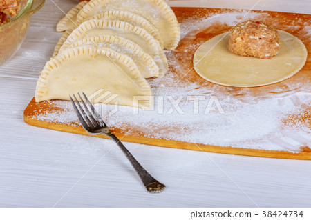 Traditional crimean tatar cheburek is ready to fry Traditional crimean tatar cheburek is ready to fry 38424734