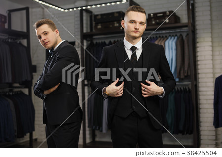 two gay friends in classic vest against row of two gay friends in classic vest against row of 38425504
