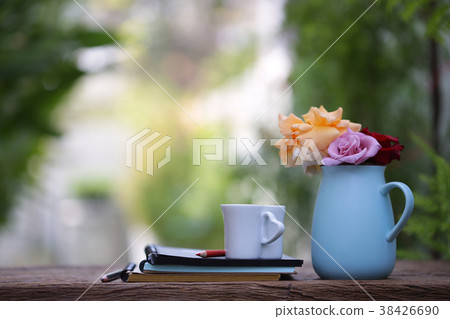 Colorful Roses in blue pot with notebook Colorful Roses in blue pot with notebook 38426690