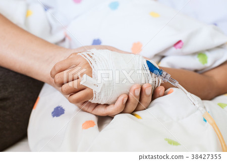 Mother hand holding sick daughter hand 38427355