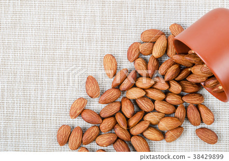 Almond seed with brown bowl. 38429899