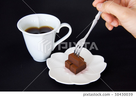 Image of raw chocolate and coffee stabbed with fork (black background) 38430039