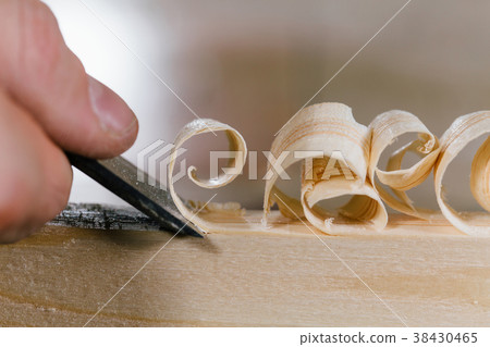 close-up carpenter man's hand treats the tree 38430465