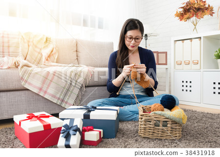 woman knitting making Christmas holiday gift 38431918