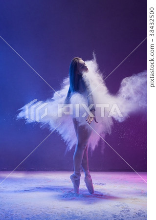 Woman in pointe shoe in dust cloud and color light 38432500