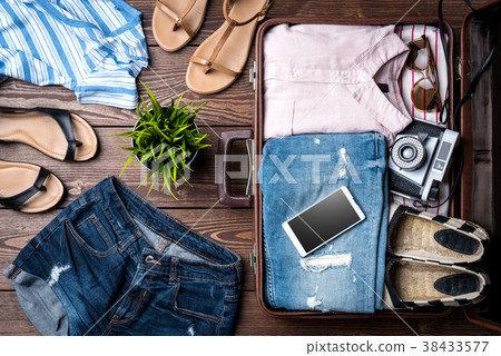 Open suitcase with casual female clothes 38433577