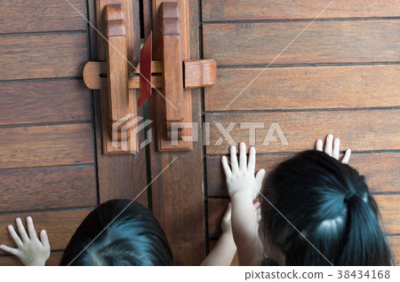 two asian girls hand push wooden door with envelop 38434168