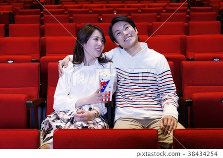 Men and women watching movies 38434254