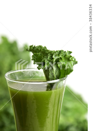 kale smoothie in a glass topped with a kale leaf 38436334