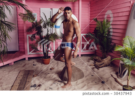 Sexy african american man in shorts standing on 38437943