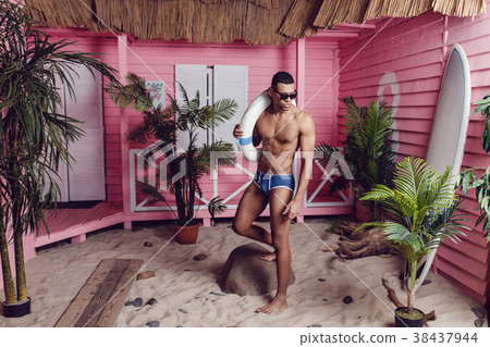 Sexy african american man in shorts standing on 38437944