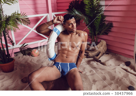 Sexy african american man in shorts sitting on the Sexy african american man in shorts sitting on the 38437966