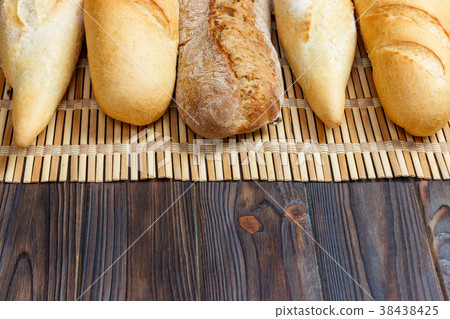 different types of baguette on a wooden background 38438425