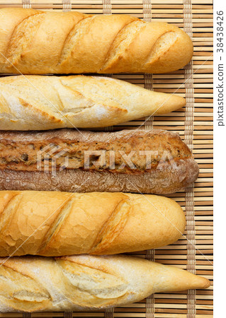 Assortment of fresh French baguettes on table 38438426