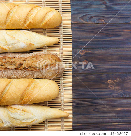 Freshly baked French baguettes on white table 38438427